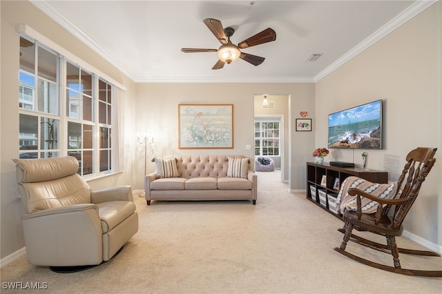 carpeted living room with ornamental molding and ceiling fan