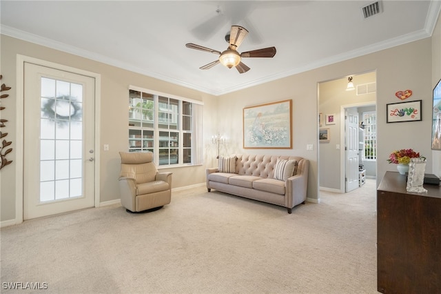 carpeted living room featuring crown molding and ceiling fan