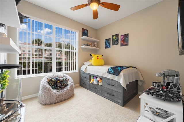 bedroom with multiple windows, light carpet, and ceiling fan