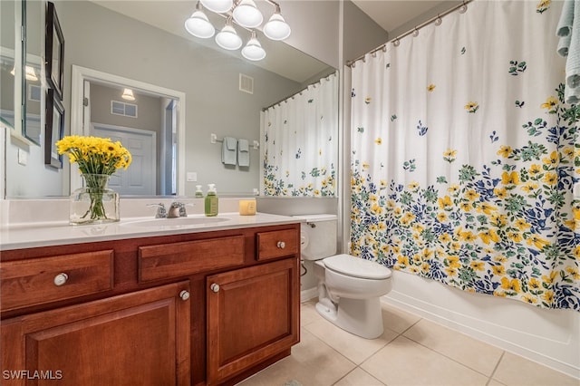 bathroom featuring vanity, tile patterned flooring, and toilet