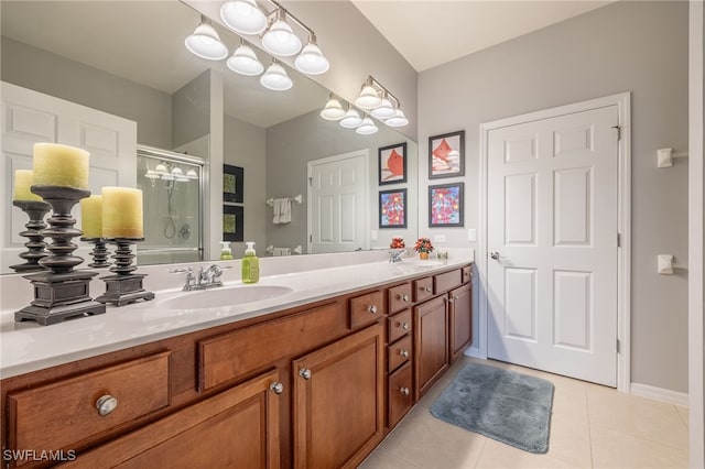 bathroom featuring tile patterned floors, vanity, and a shower with door