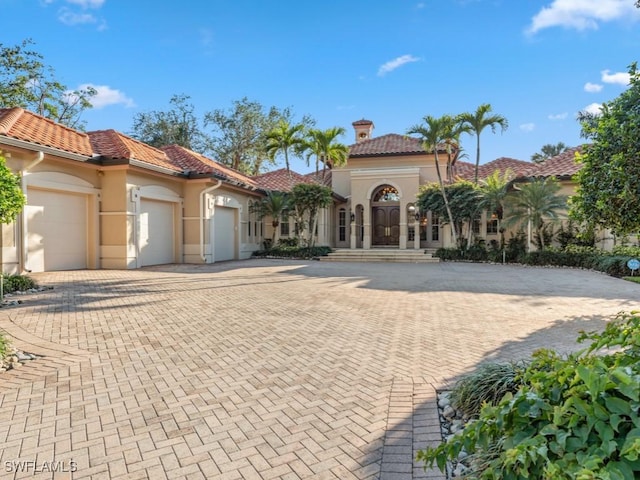 mediterranean / spanish house featuring a garage