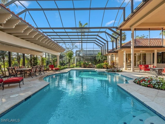 view of pool with a lanai and a patio