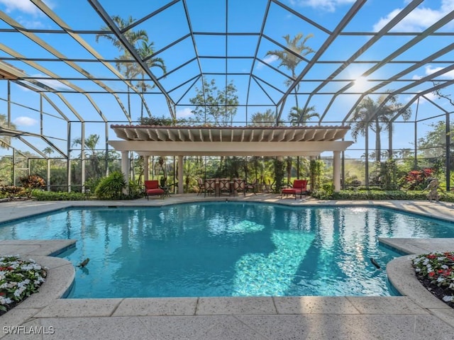 view of pool with a patio and glass enclosure