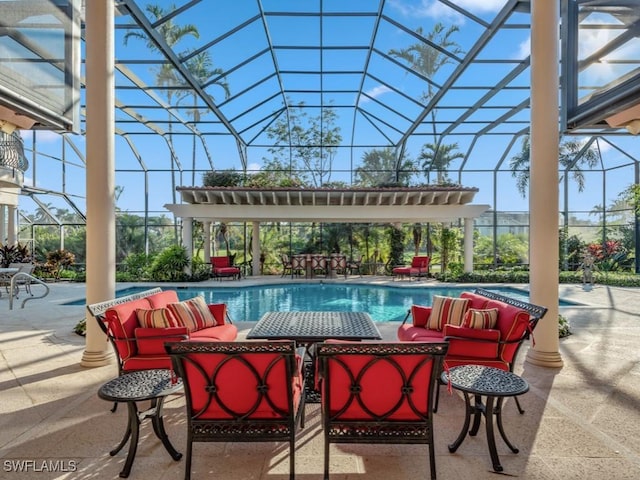 view of swimming pool with an outdoor living space, a patio, and a lanai