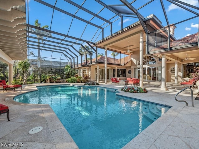 view of pool with a lanai, a patio, and ceiling fan