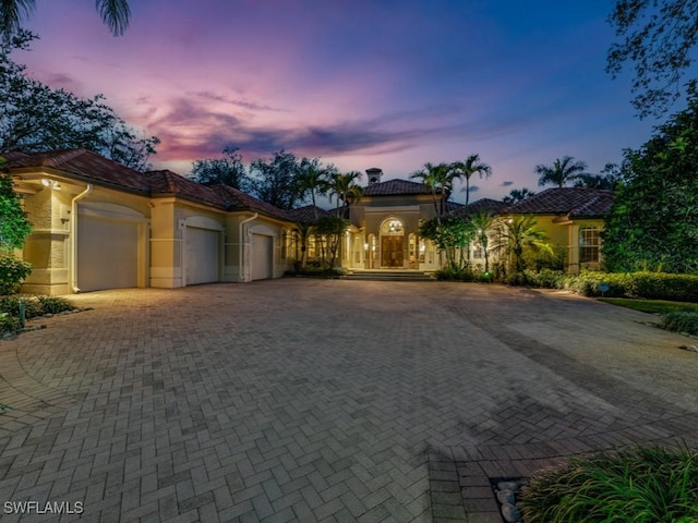 mediterranean / spanish-style house with a garage