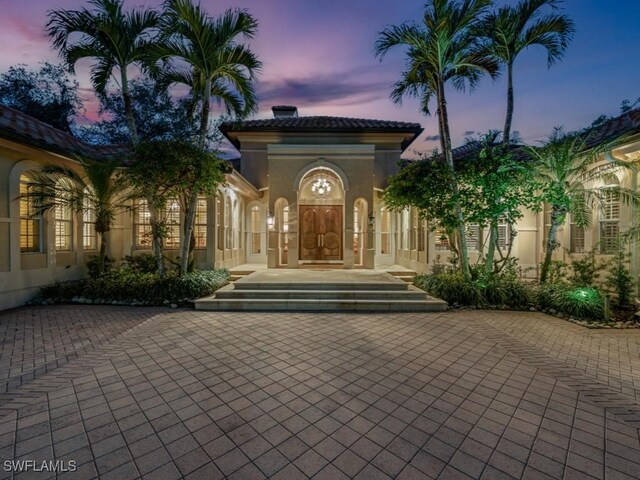 view of exterior entry at dusk