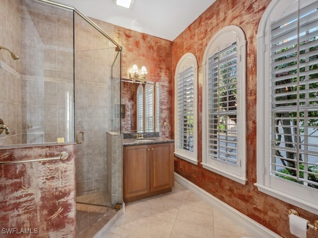 bathroom featuring vanity and a shower with door