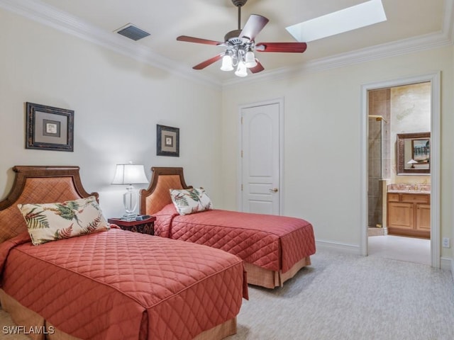 carpeted bedroom with ornamental molding, ensuite bathroom, ceiling fan, and a skylight