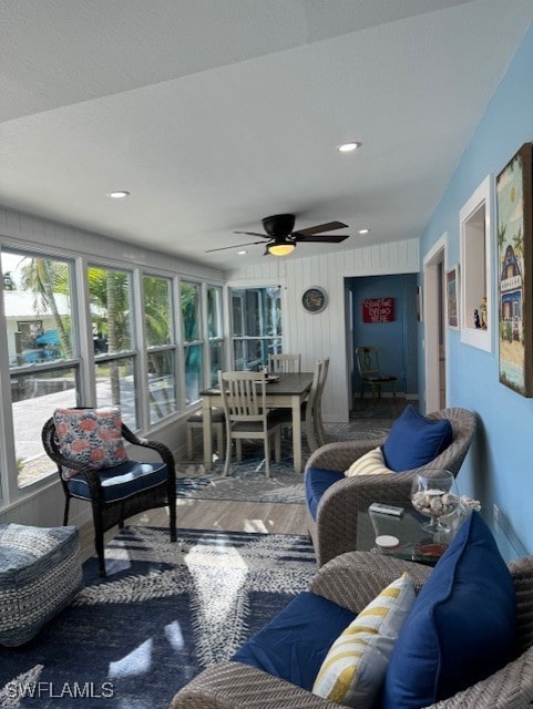 sunroom / solarium featuring a ceiling fan