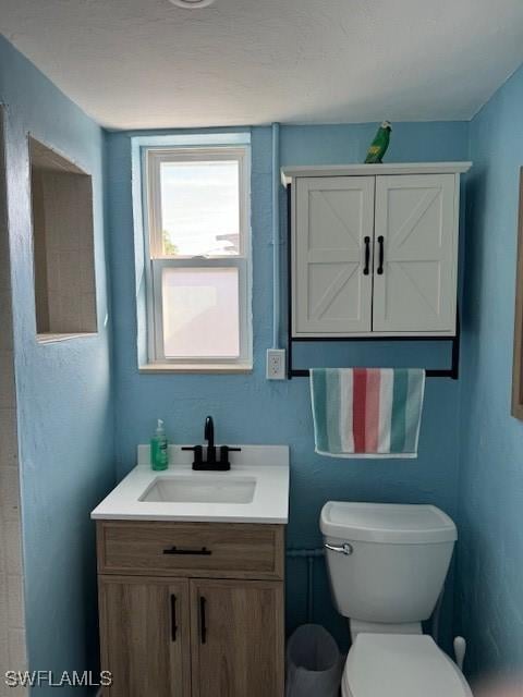 bathroom featuring toilet and vanity