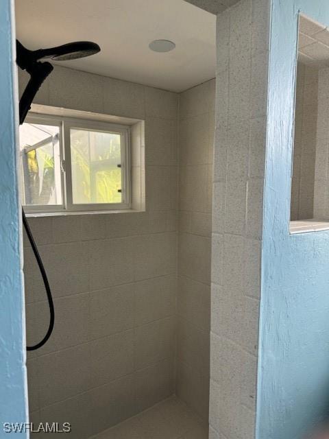 full bathroom with a tile shower