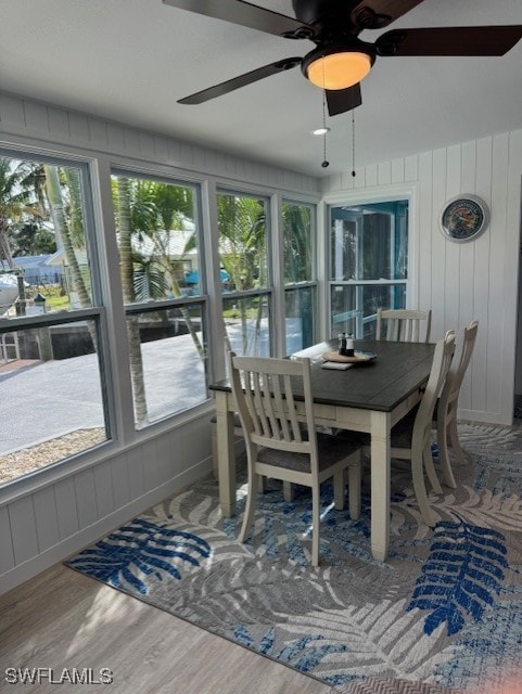 sunroom / solarium featuring ceiling fan