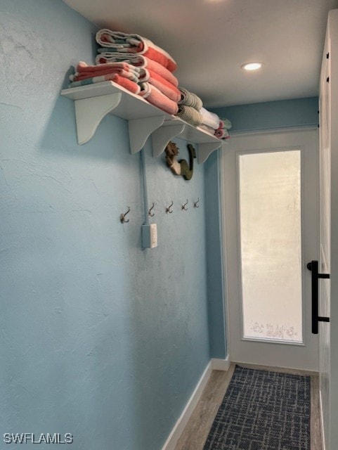 entryway with wood finished floors and baseboards