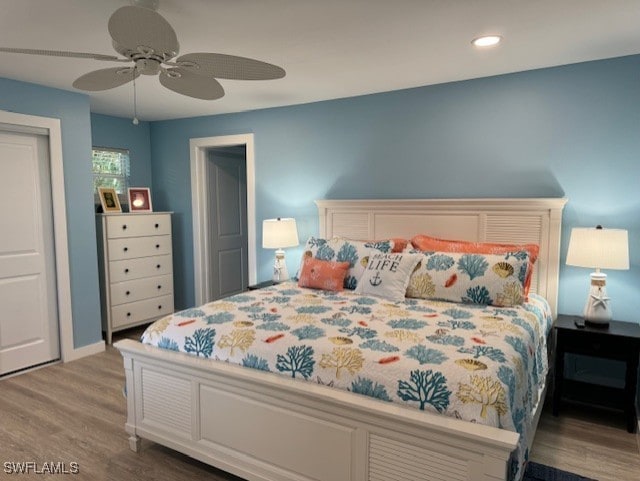 bedroom featuring wood finished floors, a ceiling fan, and recessed lighting