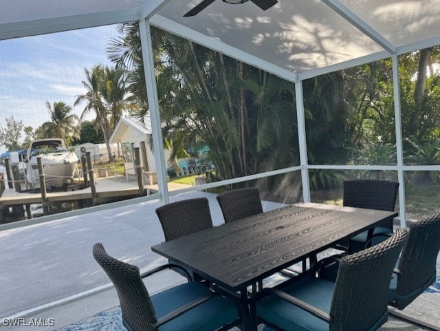 sunroom / solarium with a healthy amount of sunlight and a ceiling fan