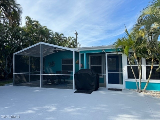 rear view of house featuring a carport, a lanai, and a patio area