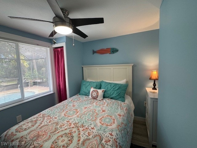 bedroom with a ceiling fan and wood finished floors