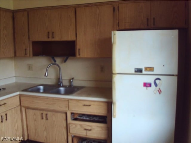 kitchen with sink and white refrigerator