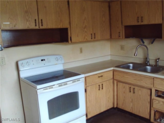 kitchen with white range with electric cooktop and sink