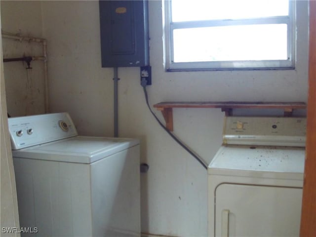 clothes washing area with electric panel and washing machine and clothes dryer