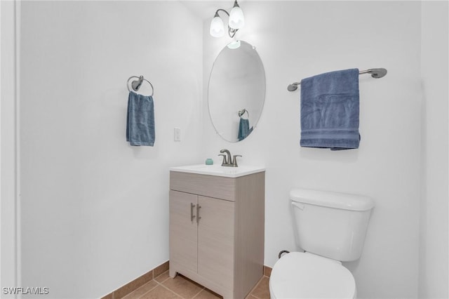 bathroom with vanity, tile patterned floors, and toilet