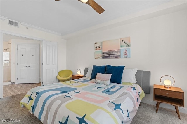 carpeted bedroom with ceiling fan and ornamental molding