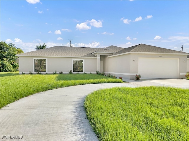 view of front of house with a garage and a front yard