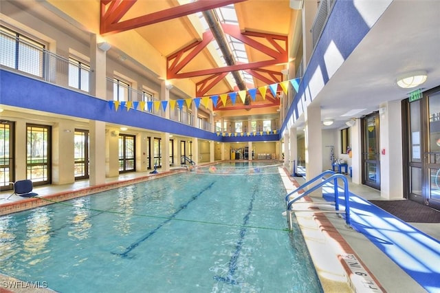 view of swimming pool with an indoor hot tub