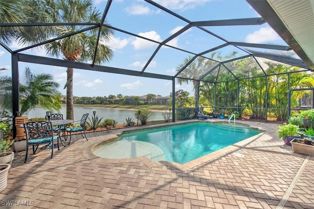 view of pool featuring a patio, a water view, and a lanai