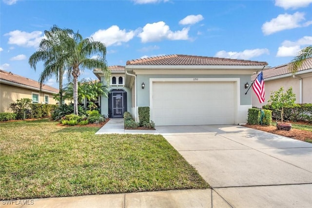 mediterranean / spanish-style house featuring a garage and a front lawn