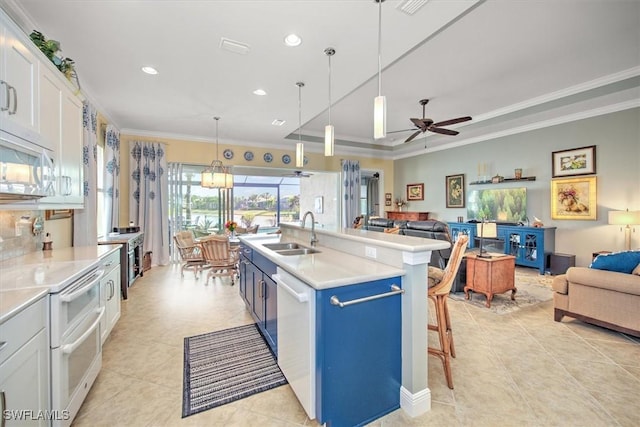 kitchen featuring sink, white cabinets, and ornamental molding