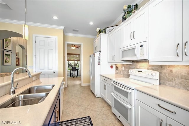 kitchen featuring white appliances, white cabinets, decorative light fixtures, sink, and crown molding