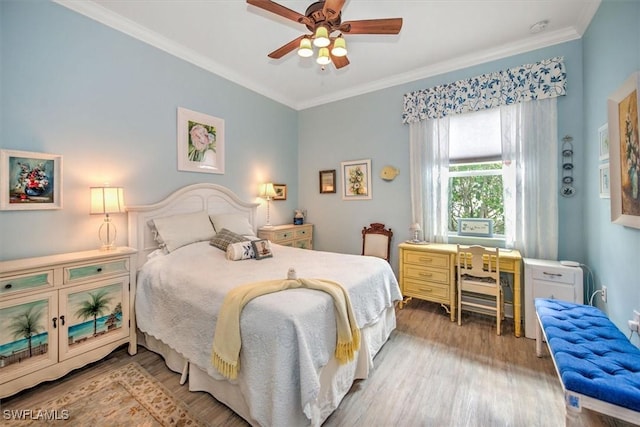 bedroom with ceiling fan, ornamental molding, and wood-type flooring