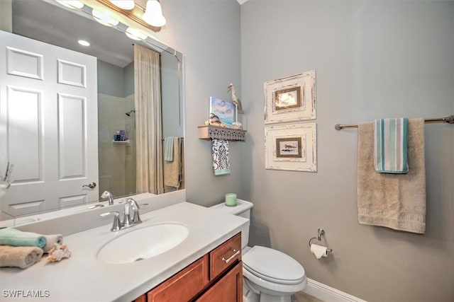 bathroom featuring vanity, toilet, and a tile shower