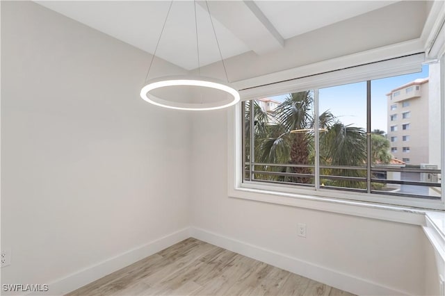 interior space featuring beamed ceiling and light wood-type flooring