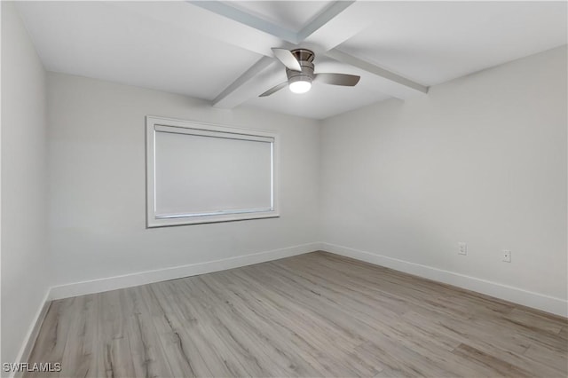 empty room featuring beam ceiling, light hardwood / wood-style floors, and ceiling fan