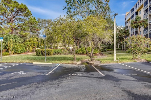 view of car parking featuring a yard