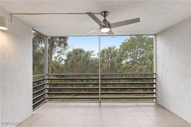 unfurnished sunroom featuring ceiling fan