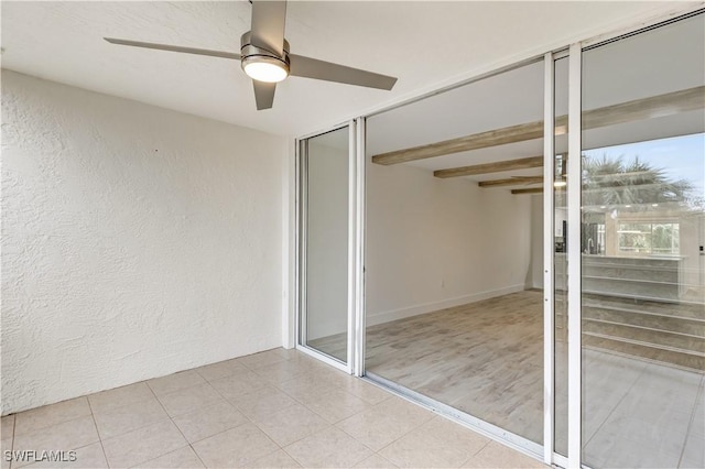 unfurnished bedroom with beamed ceiling and ceiling fan