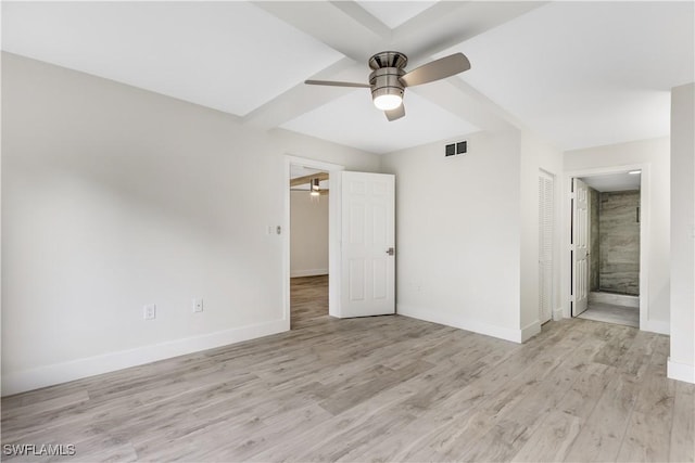 unfurnished bedroom featuring ensuite bath, light hardwood / wood-style flooring, a closet, and ceiling fan