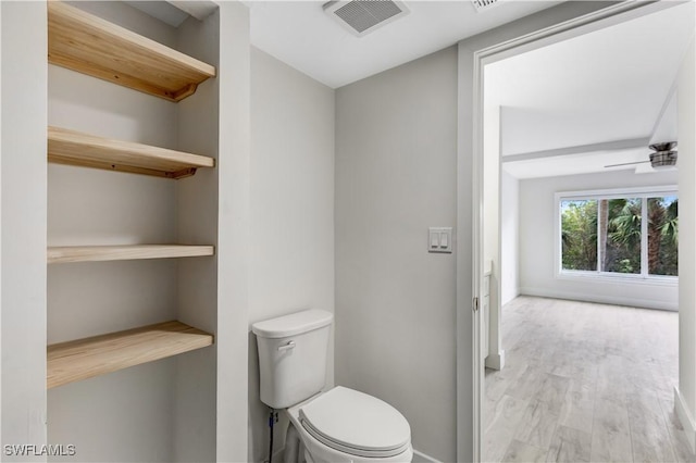 bathroom featuring hardwood / wood-style flooring and toilet