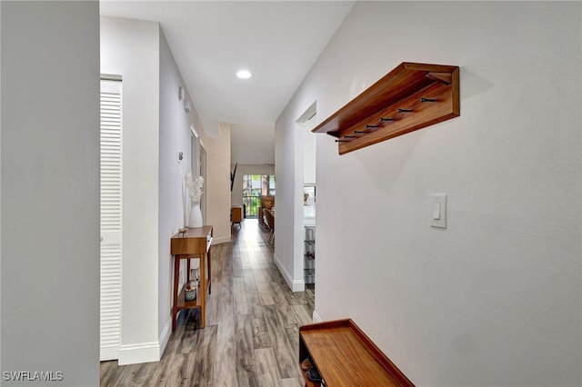 corridor with wood-type flooring