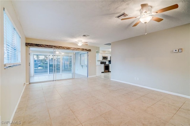 empty room featuring ceiling fan and a textured ceiling