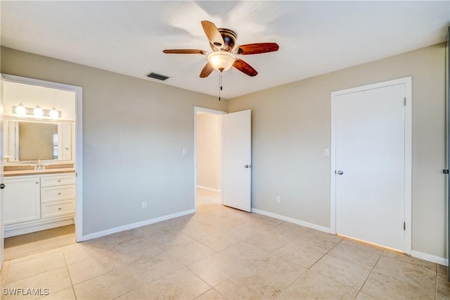 unfurnished bedroom featuring sink, ceiling fan, connected bathroom, and light tile patterned floors