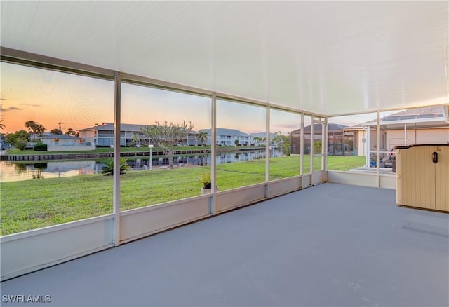 unfurnished sunroom with a water view