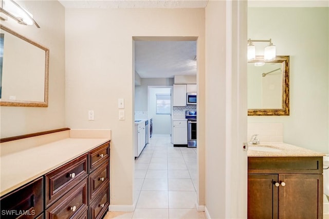 bathroom featuring vanity, tile patterned floors, and decorative backsplash