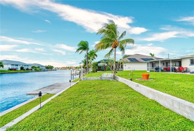 exterior space with a water view and a lawn