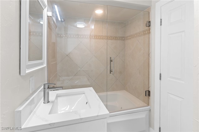 full bathroom featuring vanity and bath / shower combo with glass door